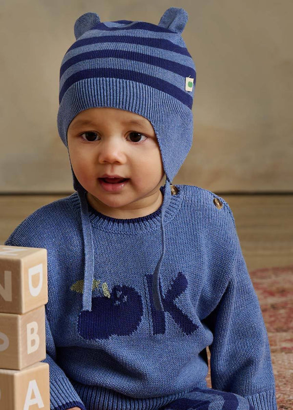 Child wearing a blue cotton knit sweater and hat with animal ears