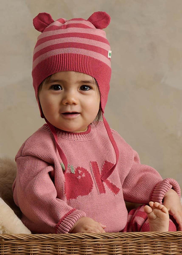Baby wearing a pink cotton knitted sweater with a design with a hat and sweater