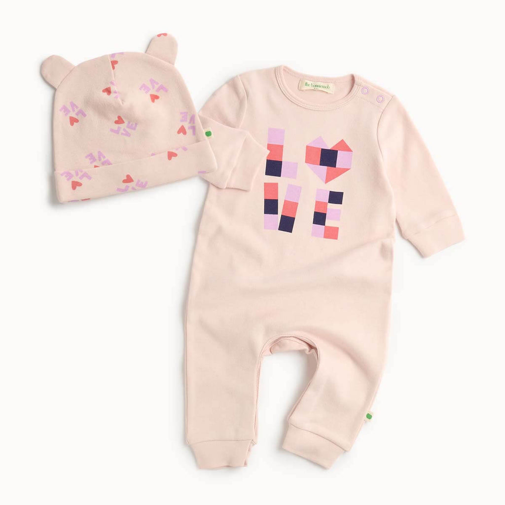 Pink cotton baby playsuit and hat set with heart patterns 