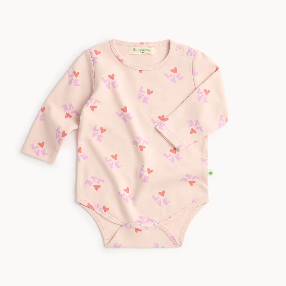 Pink cotton baby bodysuit with heart pattern 