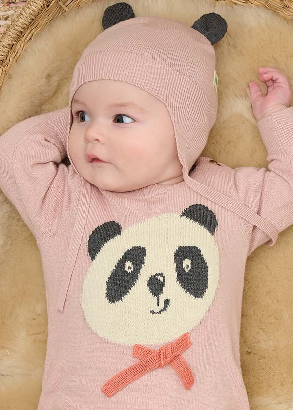 Baby wearing a pink outfit with a panda design and matching hat